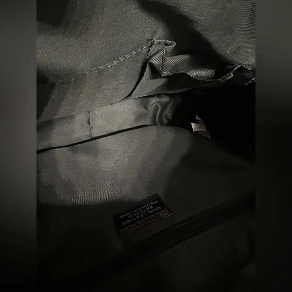 Green Backpack with Rugged Design and Leather Material